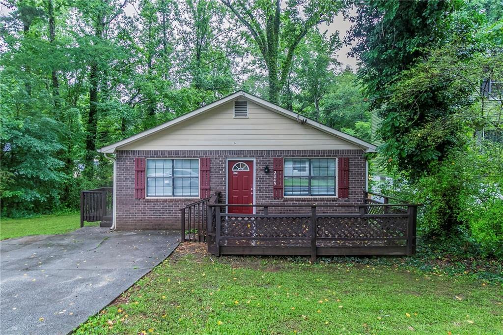 2045 Scarbrough Drive Stone Mountain, GA 30088 - Photo 1 of 26 a view of a house with a yard and large trees
