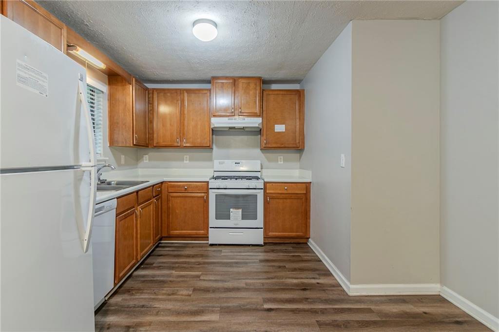 2045 Scarbrough Drive Stone Mountain, GA 30088 - Photo 11 of 26 a kitchen with stainless steel appliances granite countertop a stove a sink and a refrigerator