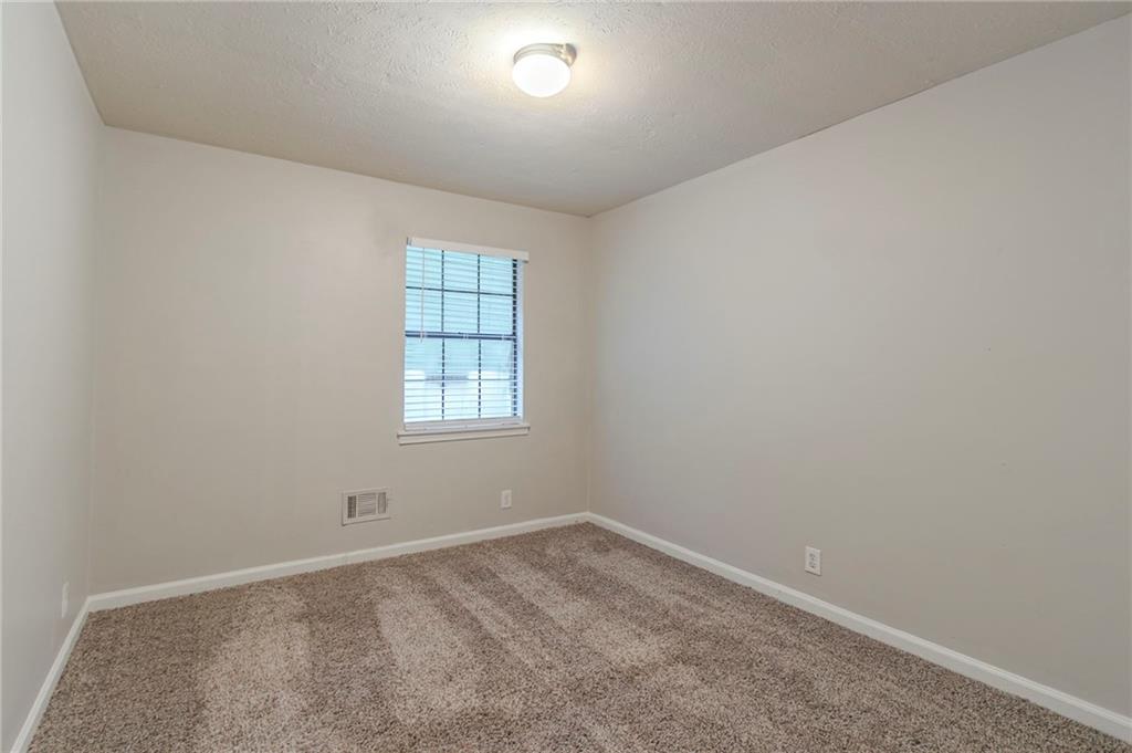 2045 Scarbrough Drive Stone Mountain, GA 30088 - Photo 15 of 26 an empty room with a window