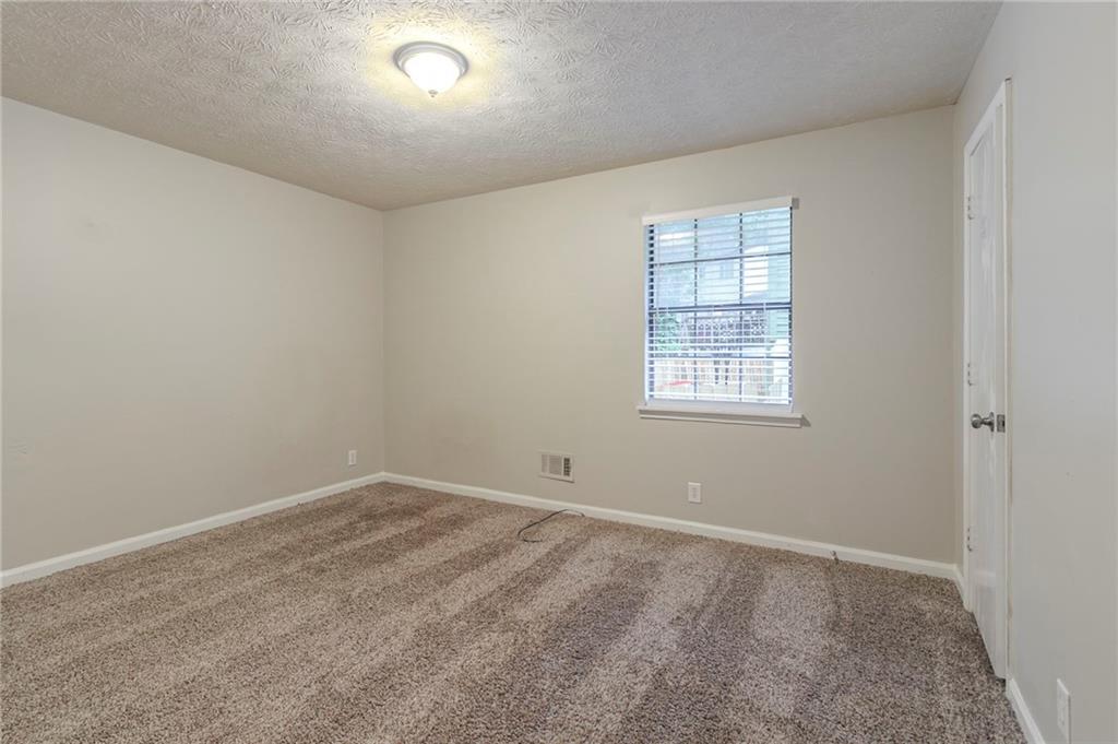 2045 Scarbrough Drive Stone Mountain, GA 30088 - Photo 17 of 26 an empty room with windows