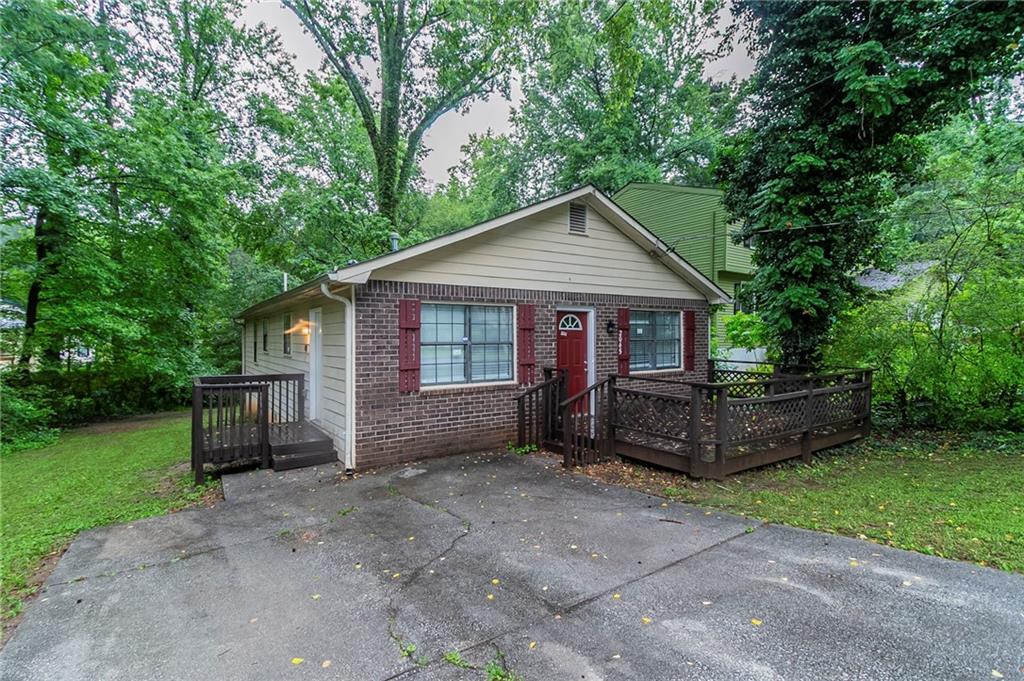 2045 Scarbrough Drive Stone Mountain, GA 30088 - Photo 2 of 26 a front view of a house with garden