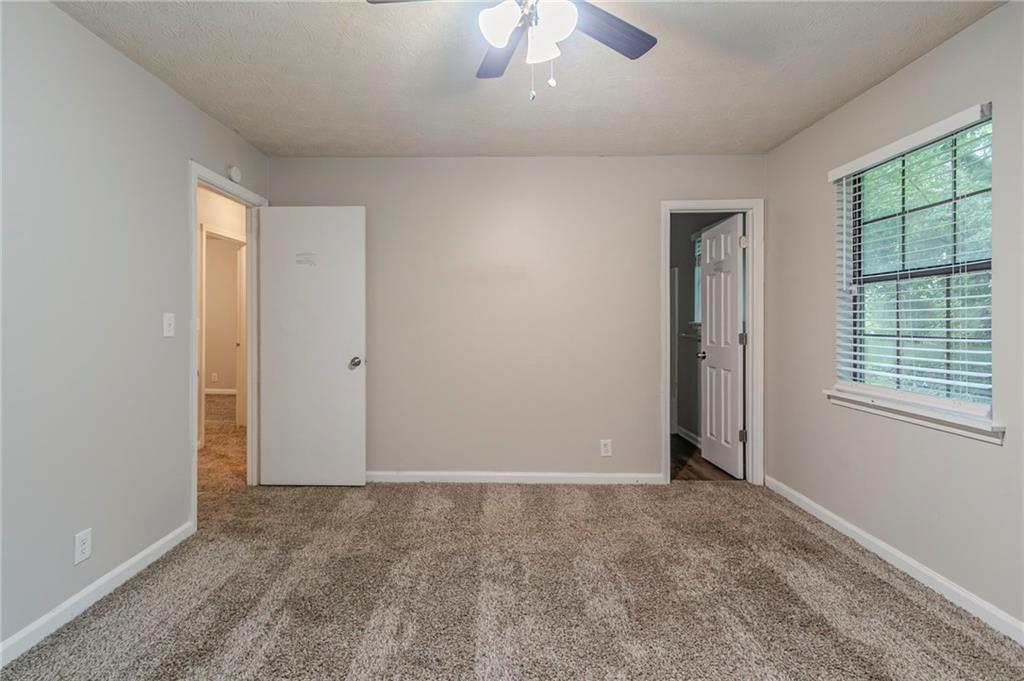 2045 Scarbrough Drive Stone Mountain, GA 30088 - Photo 21 of 26 an empty room with windows and closet