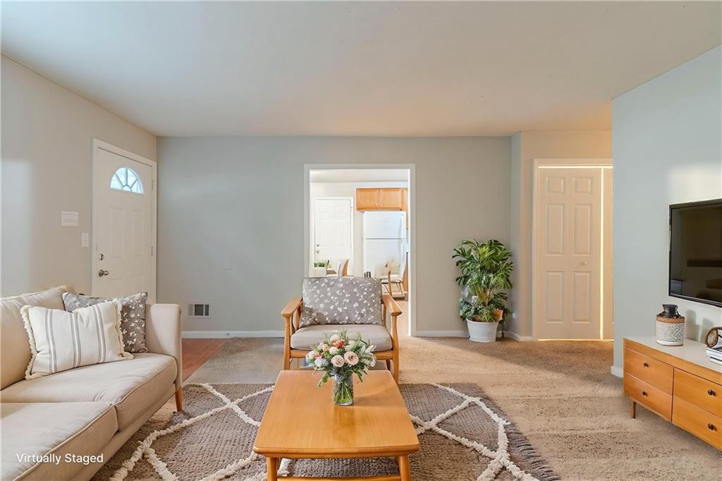 2045 Scarbrough Drive Stone Mountain, GA 30088 - Photo 4 of 26 a living room with furniture and a flat screen tv