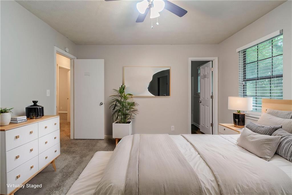 2045 Scarbrough Drive Stone Mountain, GA 30088 - Photo 7 of 26 a bedroom with a bed and a potted plant