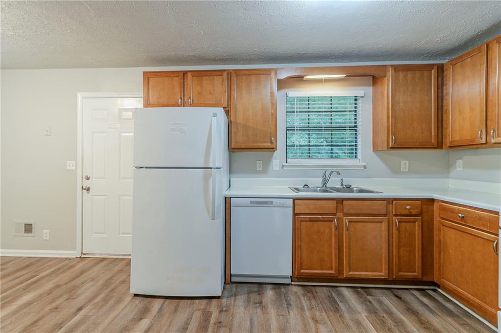 2045 Scarbrough Drive Stone Mountain, GA 30088 - Photo 10 of 26 a white refrigerator freezer sitting inside of a kitchen