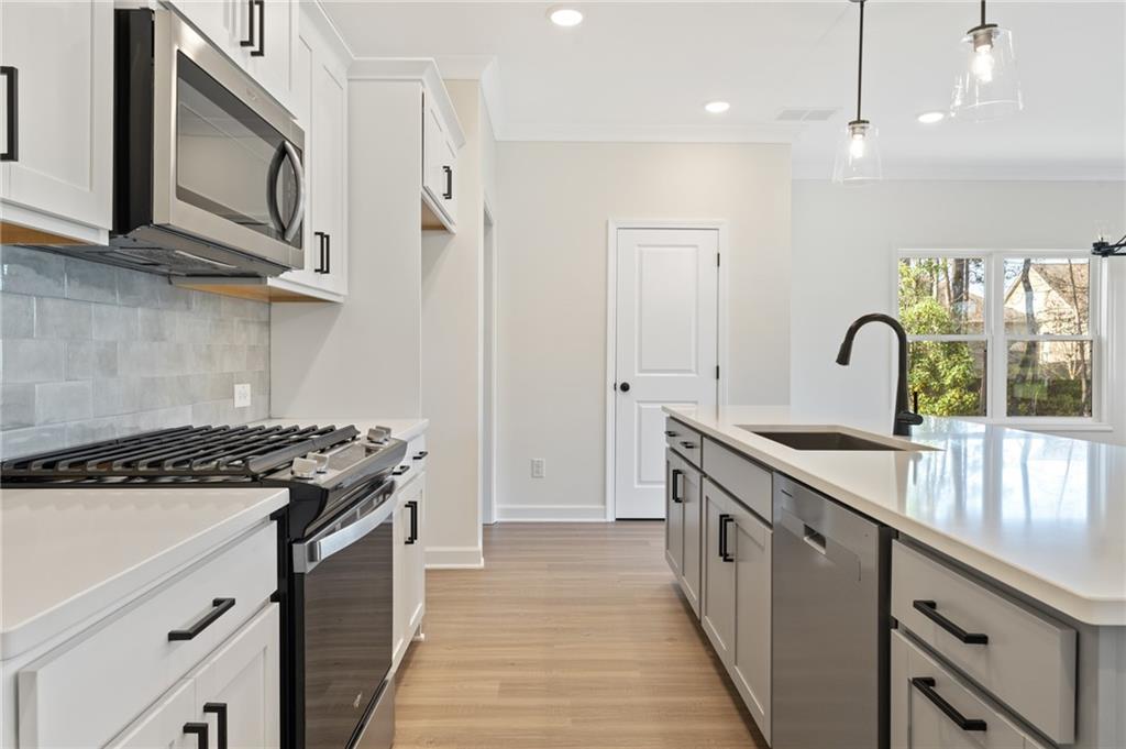 325 Colsen Drive Acworth, GA 30102 - Photo 6 of 25 a kitchen with stainless steel appliances granite countertop a stove a sink and a microwave