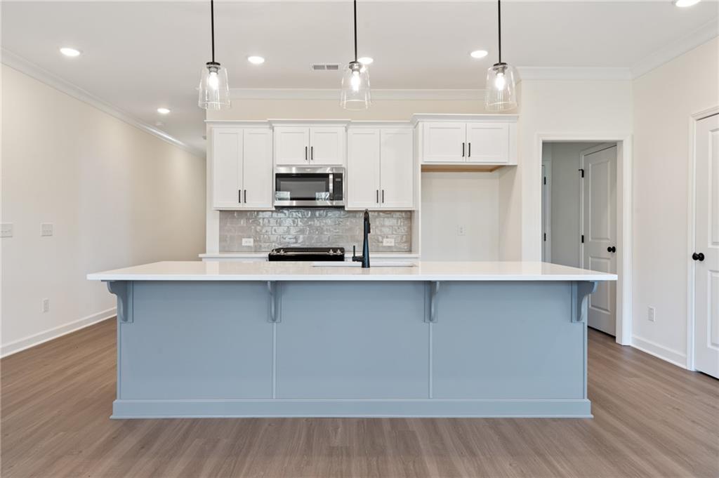 325 Colsen Drive Acworth, GA 30102 - Photo 8 of 25 a kitchen with kitchen island a sink stainless steel appliances and cabinets