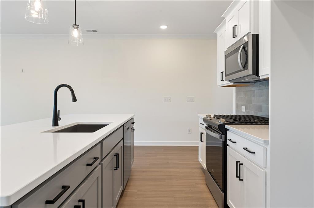 325 Colsen Drive Acworth, GA 30102 - Photo 9 of 25 a kitchen with stainless steel appliances granite countertop a sink stove and refrigerator