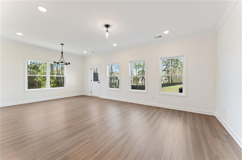 325 Colsen Drive Acworth, GA 30102 - Photo 10 of 25 an empty room with wooden floor and windows