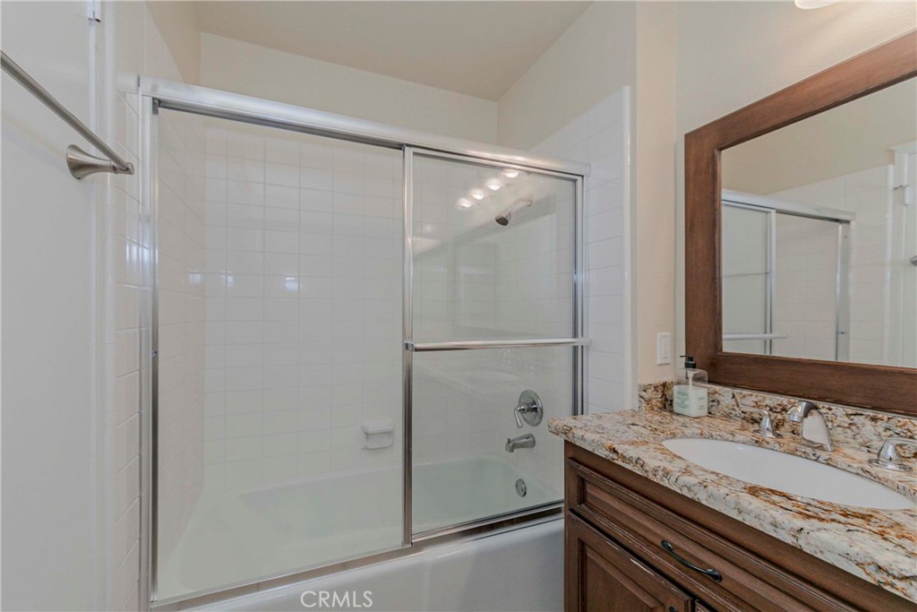 17502 De Oro Court Cerritos, CA 90703 - Photo 11 of 24 a bathroom with a granite countertop shower and a sink