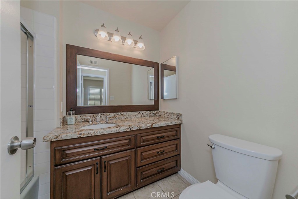 17502 De Oro Court Cerritos, CA 90703 - Photo 12 of 24 a bathroom with a toilet sink and mirror