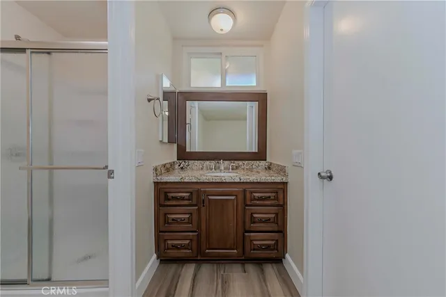 a view of kitchen with cabinets and window