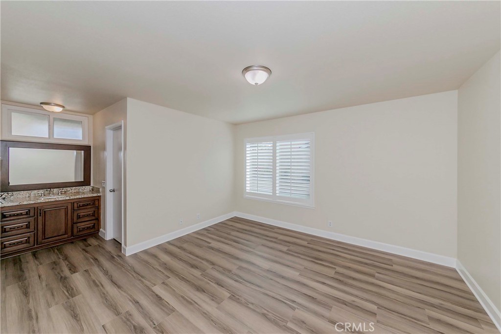 17502 De Oro Court Cerritos, CA 90703 - Photo 14 of 24 a view of kitchen and empty room with wooden floor