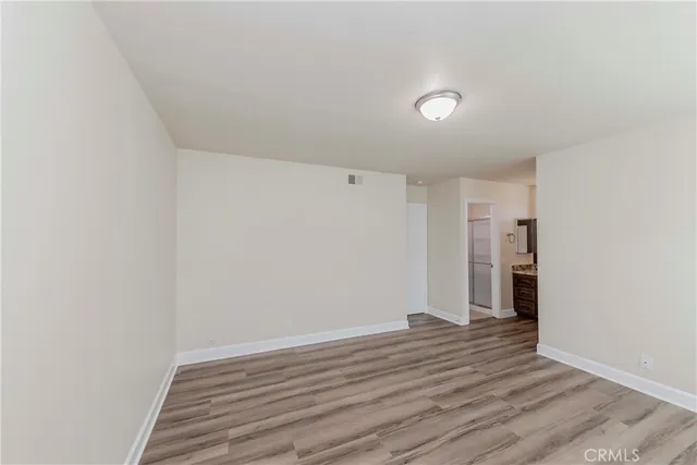 a view of wooden floor and windows in a room