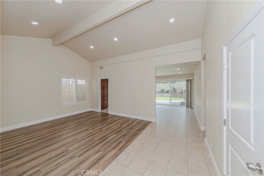 17502 De Oro Court Cerritos, CA 90703 - Photo 4 of 24 a view of an empty room with wooden floor and a window