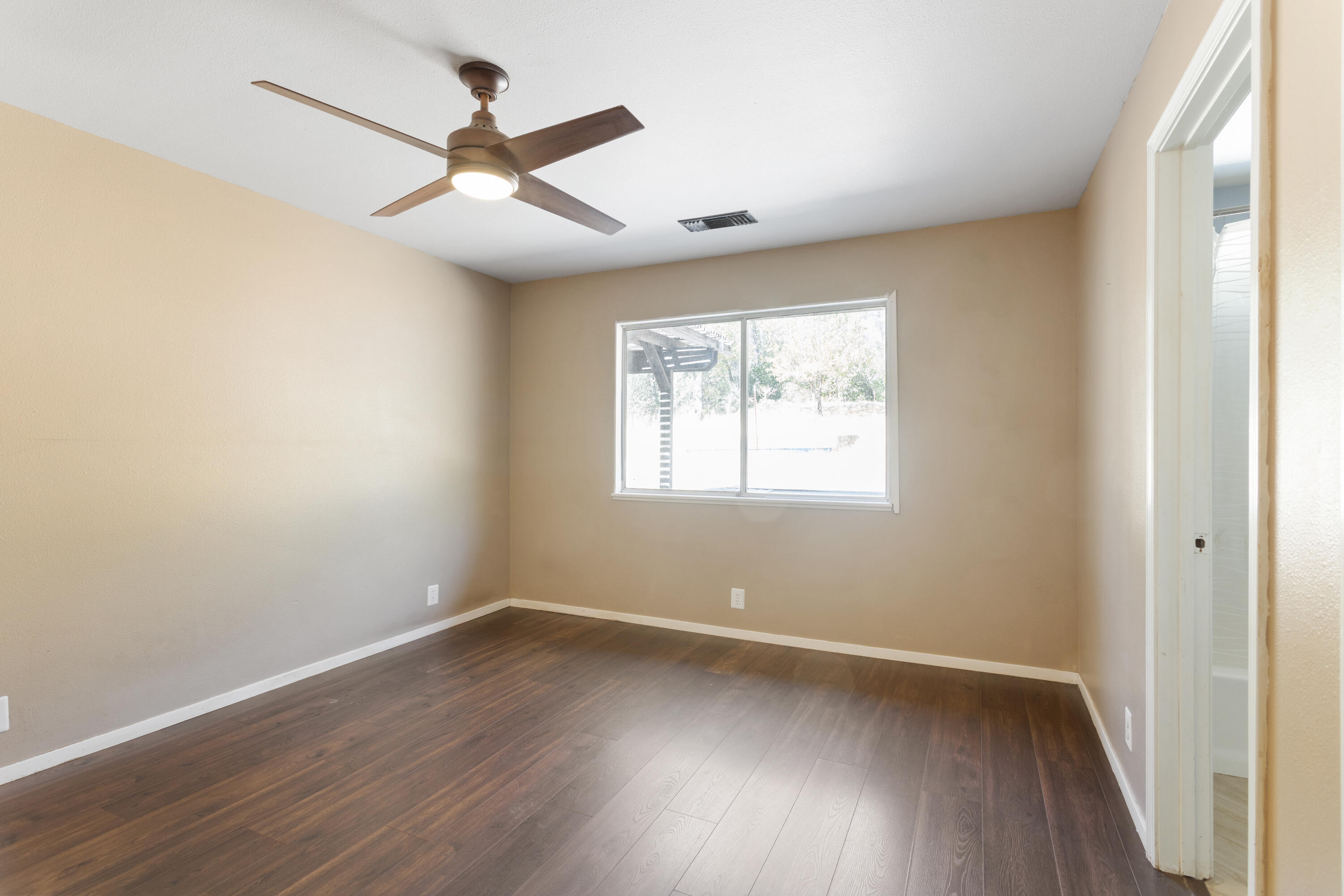 12656 Shalon Drive Redding, CA 96003 - Photo 12 of 21 wooden floor in an empty room with a window