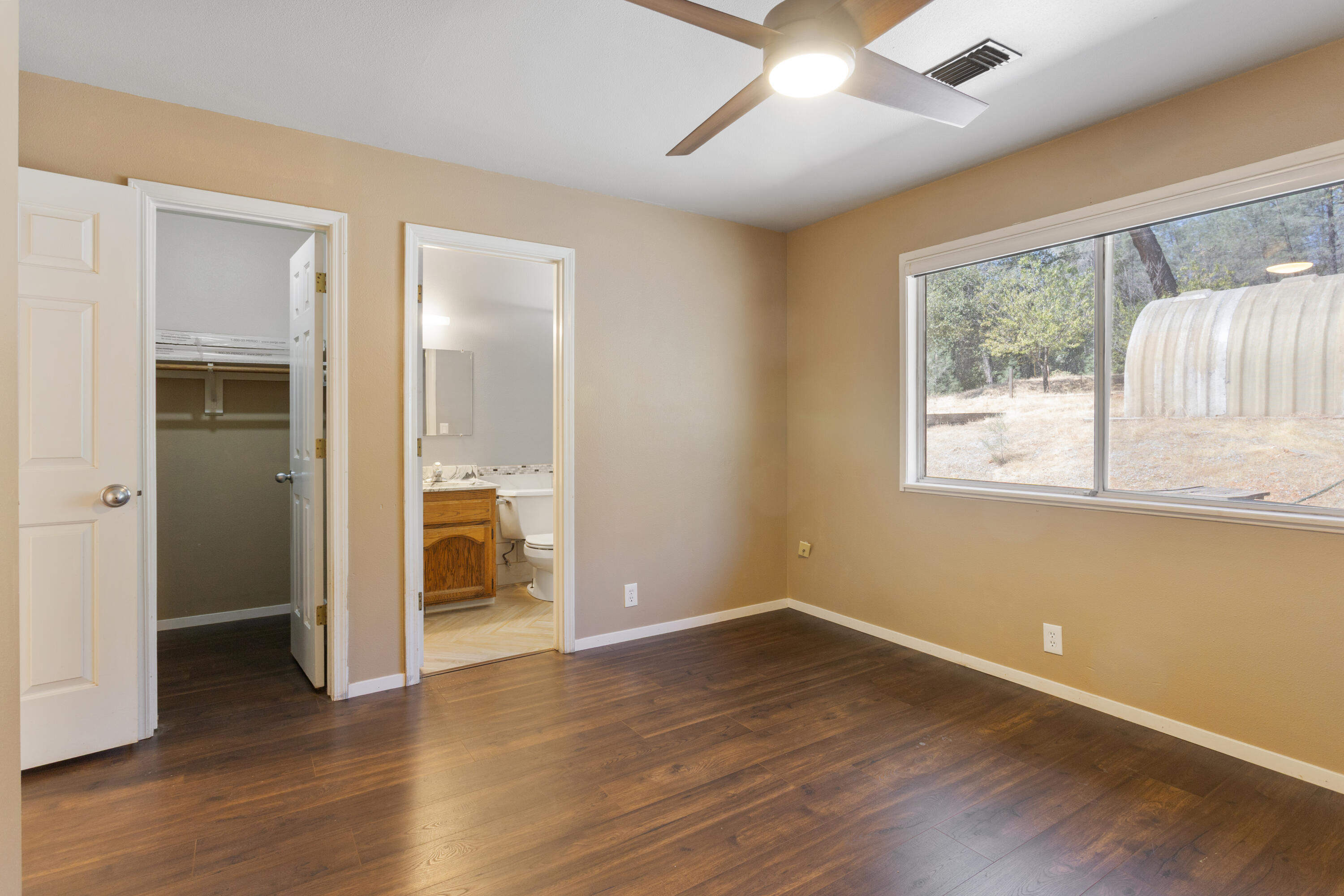 12656 Shalon Drive Redding, CA 96003 - Photo 14 of 21 a view of an empty room with wooden floor and a window