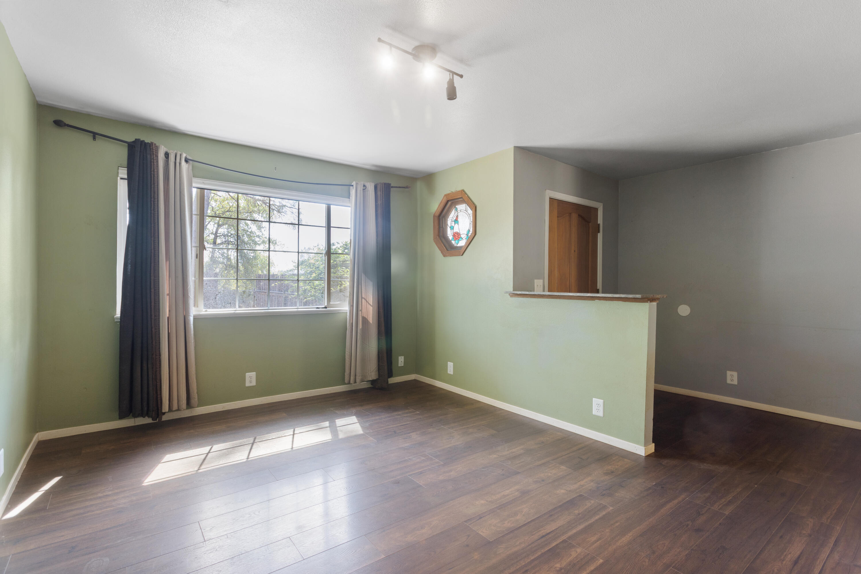 12656 Shalon Drive Redding, CA 96003 - Photo 5 of 21 an empty room with wooden floor and windows