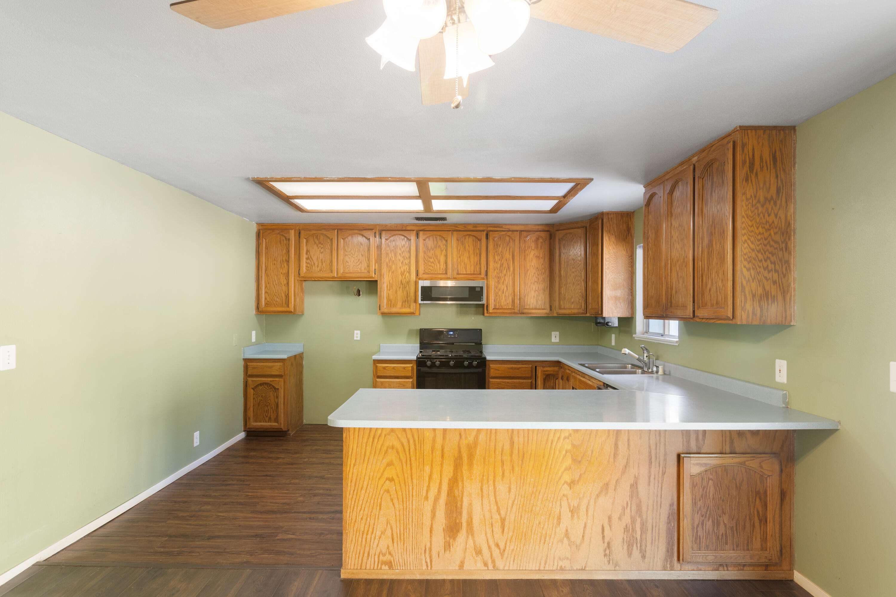 12656 Shalon Drive Redding, CA 96003 - Photo 7 of 21 a kitchen with a stove a sink and a cabinets