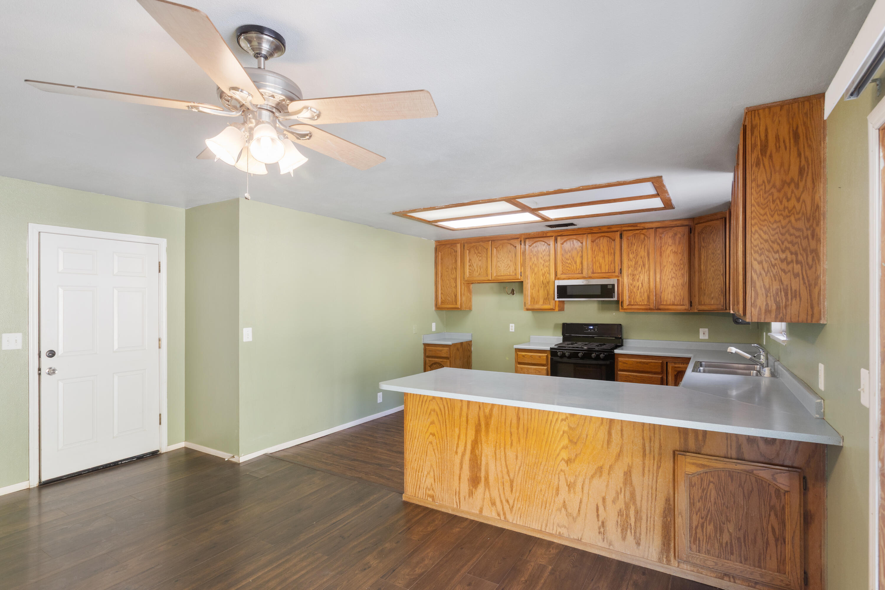 12656 Shalon Drive Redding, CA 96003 - Photo 9 of 21 a kitchen with stainless steel appliances a sink cabinets and wooden floor