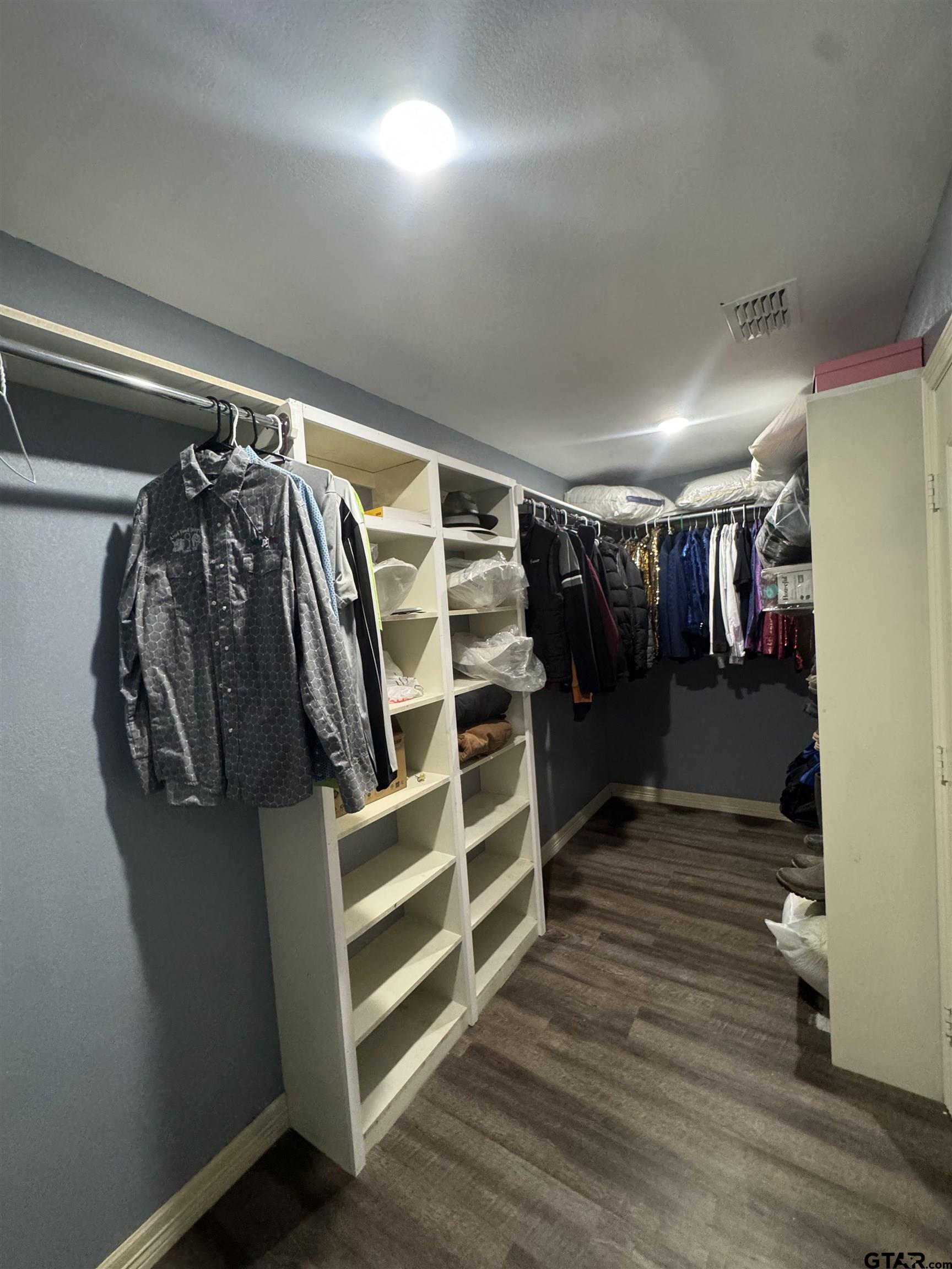 8261 County Road 381 Tyler, TX 75708 - Photo 11 of 24 a view of walk in closet with clothes and shoes