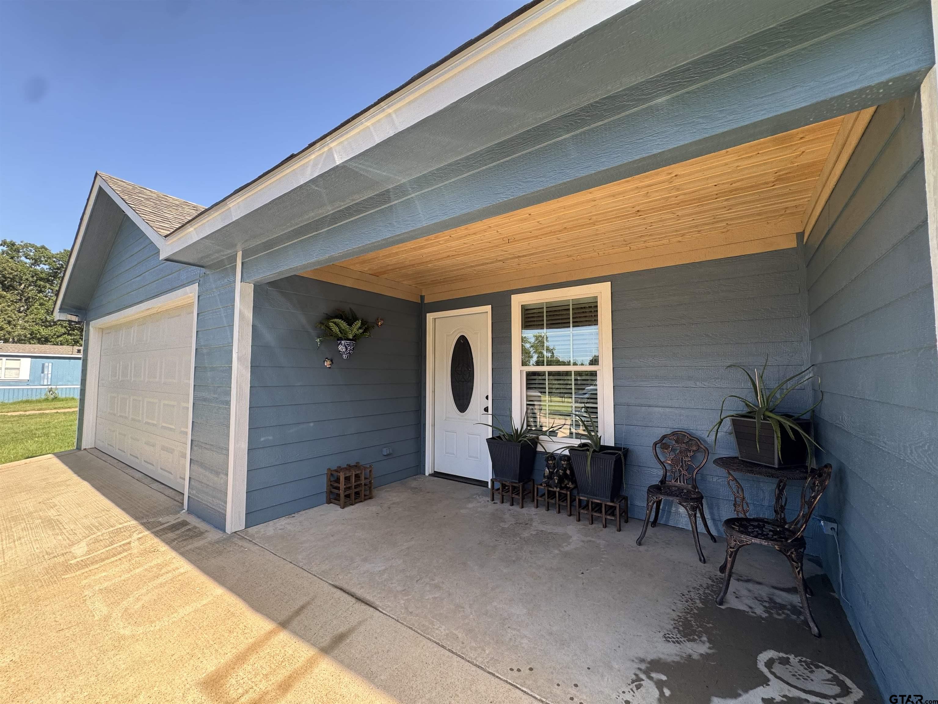 8261 County Road 381 Tyler, TX 75708 - Photo 3 of 24 a front view of a house with glass windows and furniture