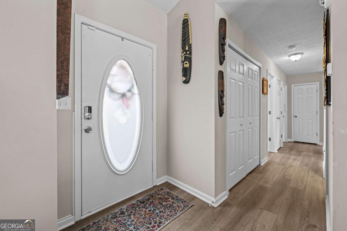 6324 Amberly Road Rex, GA 30273 - Photo 13 of 22 a view of a livingroom with wooden floor and white walls