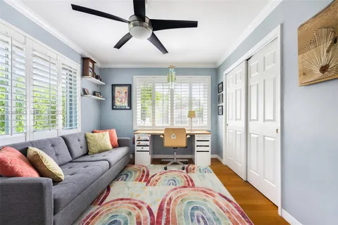 a bedroom with furniture and a large window