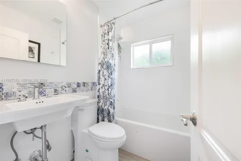 a bathroom with a sink a toilet and a bathtub