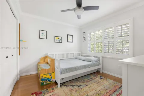 a bed sitting in a bedroom next to a window