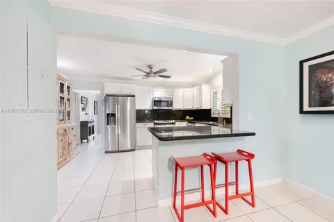 a kitchen with stainless steel appliances granite countertop a stove and a refrigerator