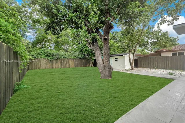 a front view of a house with a garden and yard