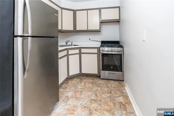 a kitchen with a refrigerator and a stove