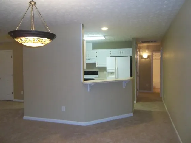 a view of a hallway with a chandelier