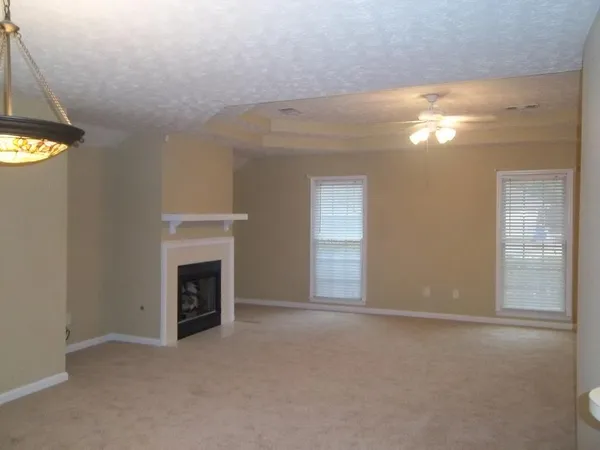 a view of empty room with window and fireplace