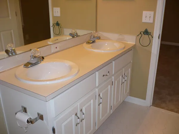 a bathroom with double vanity sink and a mirror