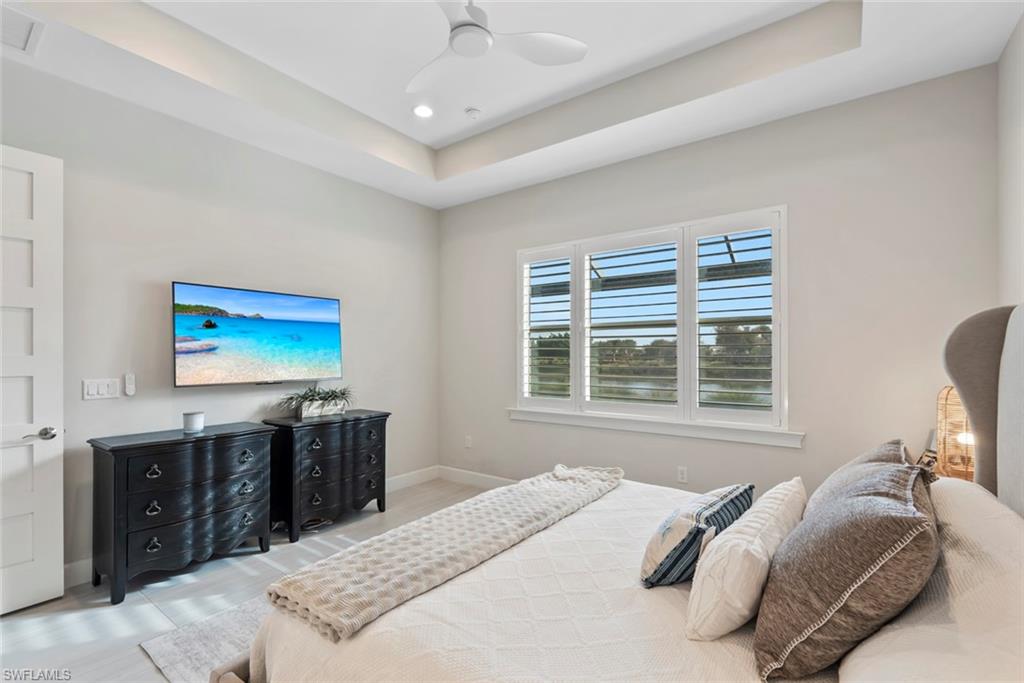 5716 Highbourne Drive Naples, FL 34113 - Photo 14 of 36 a bedroom with a bed and a flat screen tv
