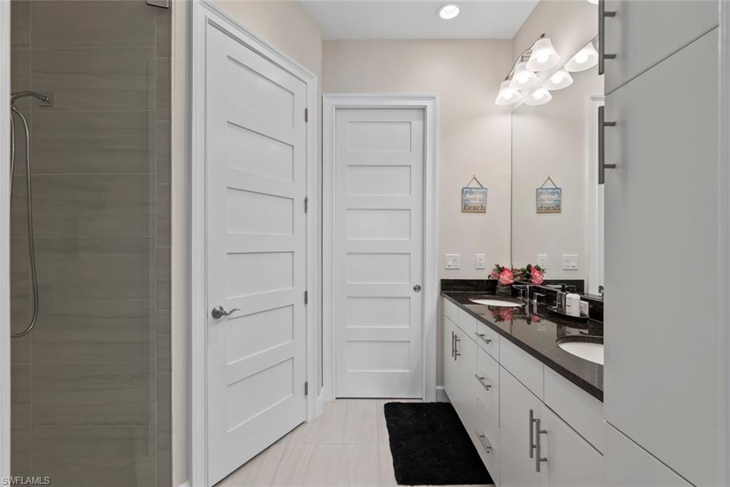 5716 Highbourne Drive Naples, FL 34113 - Photo 16 of 36 a kitchen with a sink and cabinets