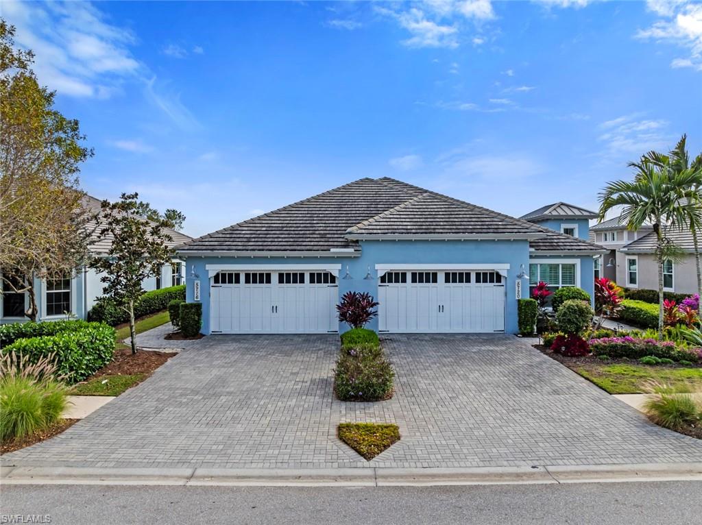 5716 Highbourne Drive Naples, FL 34113 - Photo 2 of 36 a front view of a house with yard and garage