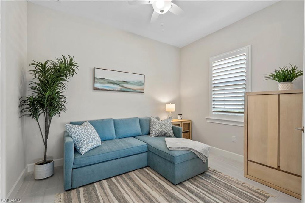 5716 Highbourne Drive Naples, FL 34113 - Photo 21 of 36 a living room with furniture and a potted plant