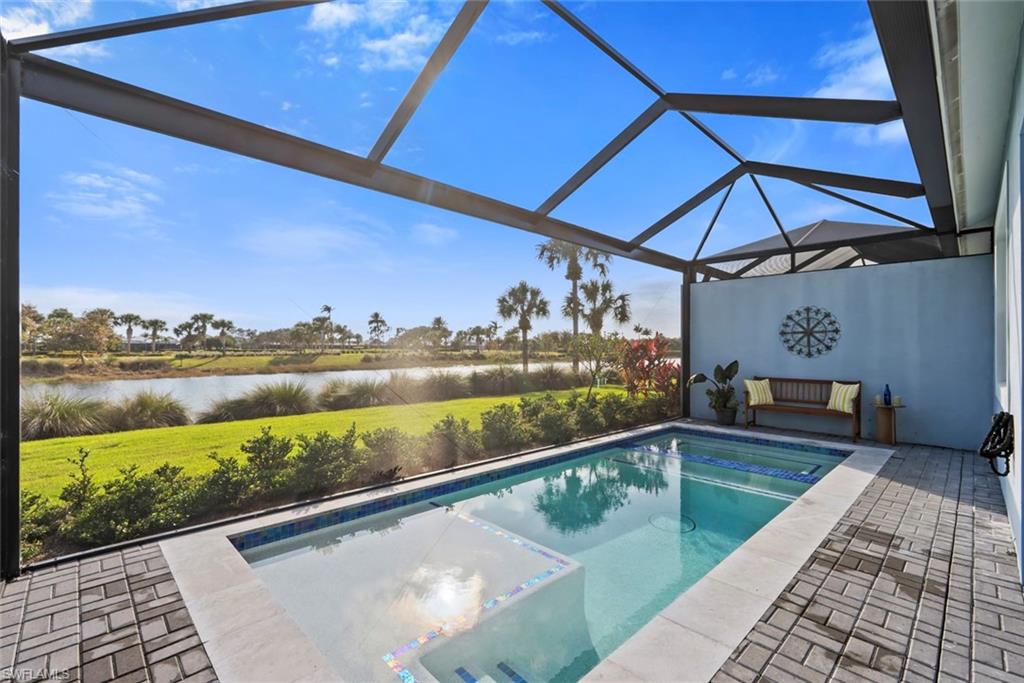 5716 Highbourne Drive Naples, FL 34113 - Photo 24 of 36 a view of a swimming pool with a patio