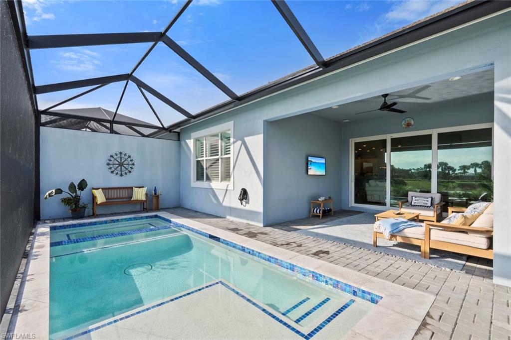 5716 Highbourne Drive Naples, FL 34113 - Photo 25 of 36 a living room filled with furniture and a table
