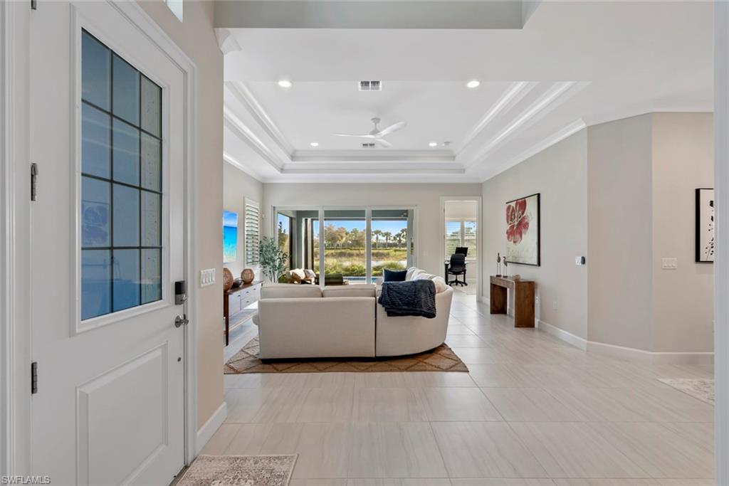 5716 Highbourne Drive Naples, FL 34113 - Photo 5 of 36 a living room with furniture and a large window
