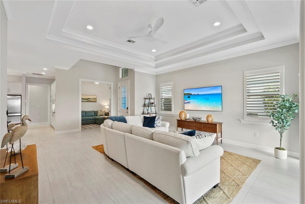 5716 Highbourne Drive Naples, FL 34113 - Photo 6 of 36 a living room with furniture and a potted plant