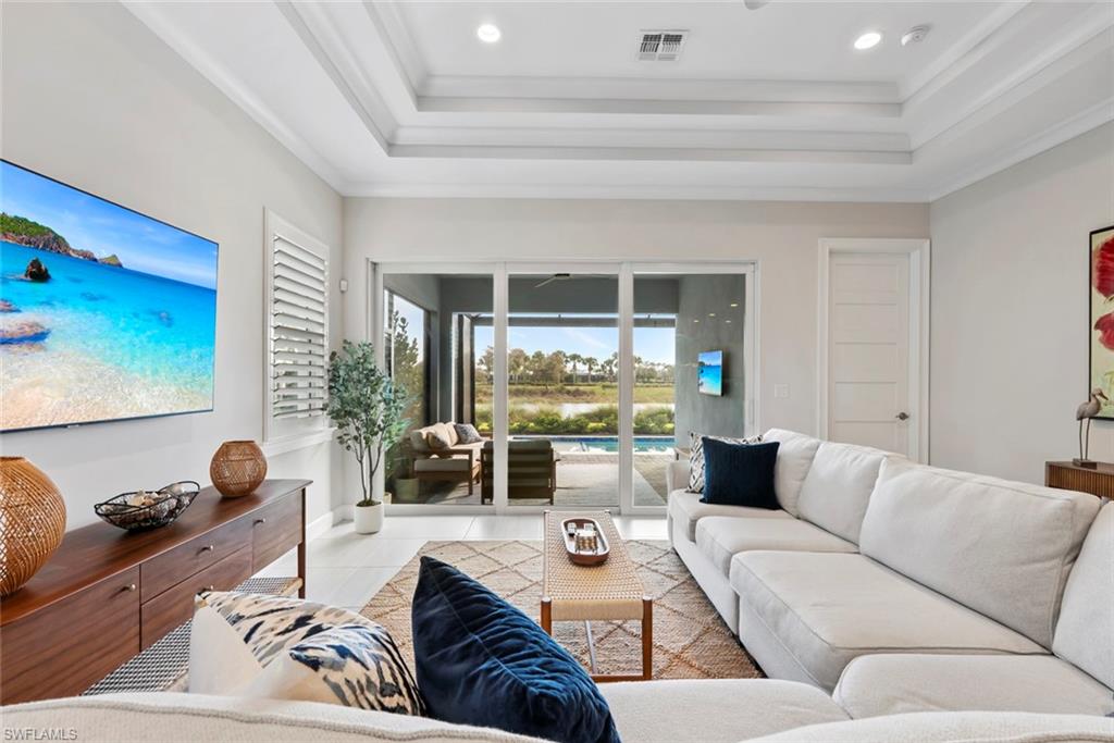 5716 Highbourne Drive Naples, FL 34113 - Photo 7 of 36 a living room with furniture and a large window