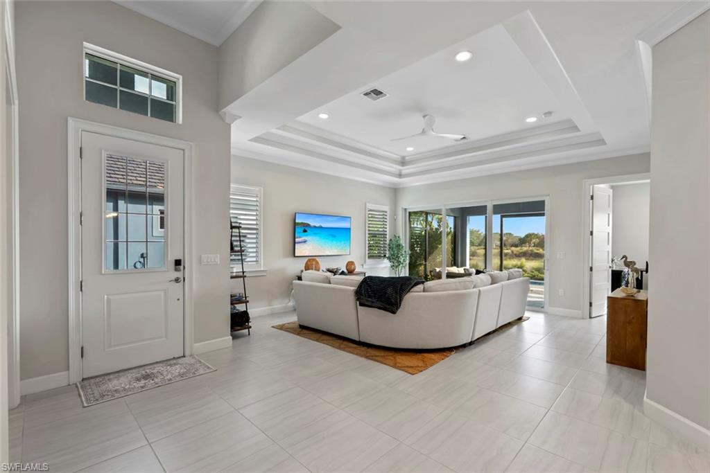 5716 Highbourne Drive Naples, FL 34113 - Photo 8 of 36 a living room with furniture and a large window
