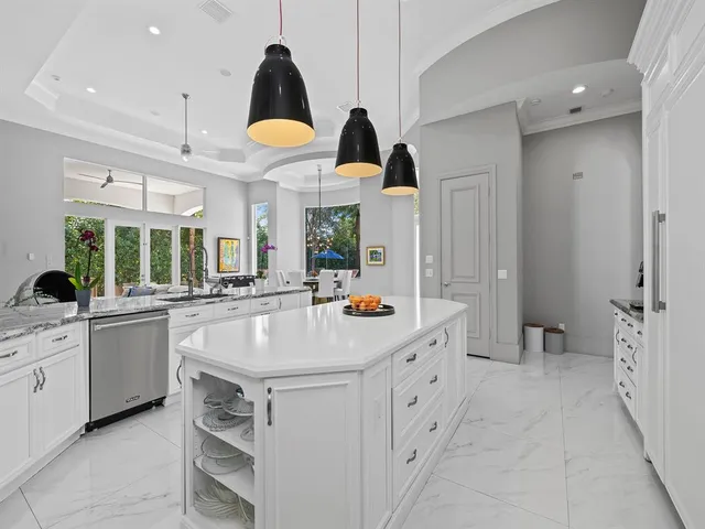 a living room with patio furniture and a chandelier