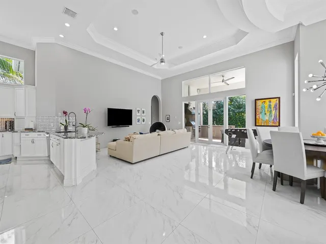 a view of a dining room with furniture a chandelier and wooden floor