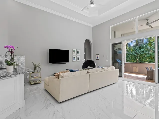 a dining room with furniture a window and a chandelier