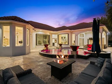 a view of a swimming pool with red chairs